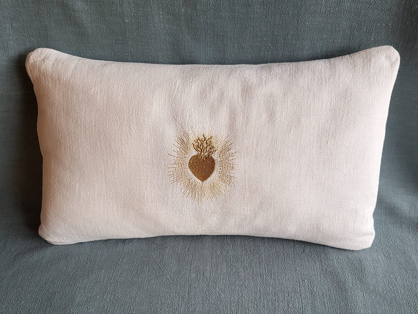 Coussin en lin blanc brodé d'un ex voto doré